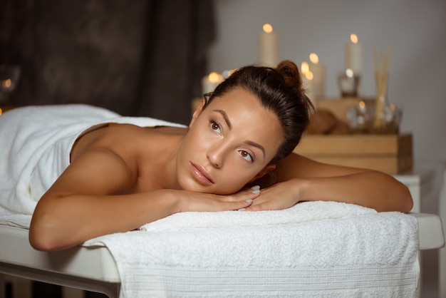 Young woman relaxing in spa salon.