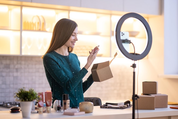 Young woman representing new facial cream and looking involved