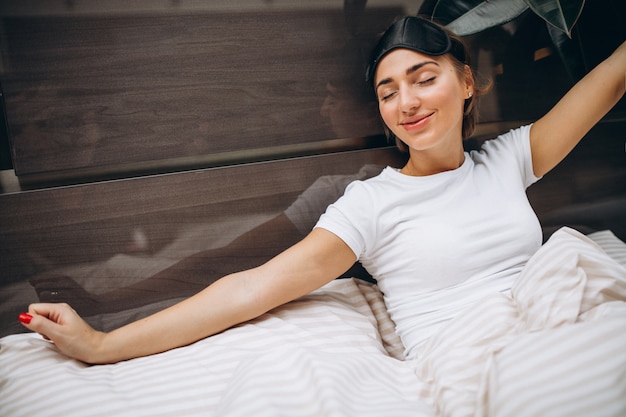 Free photo young woman resting in bed in the morning