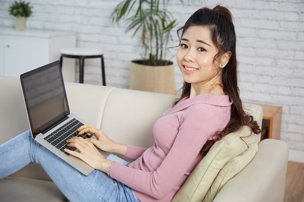 Young woman resting on laptop