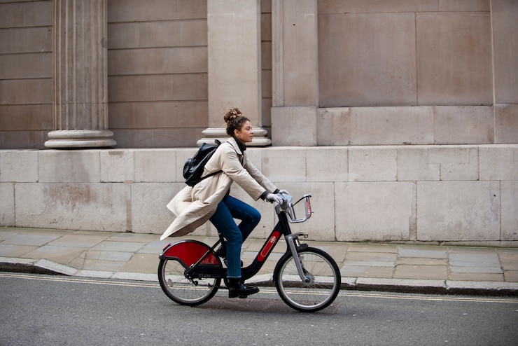 Free Photo young woman riding a bike in the city
