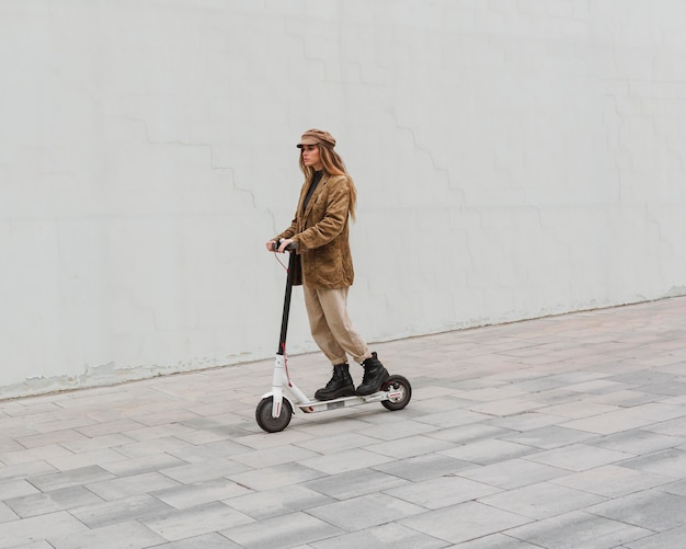 Young woman riding an electric scooter