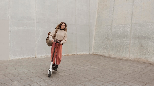 Young woman riding an electric scooter