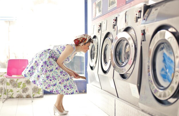 young woman in a room of public washing machines