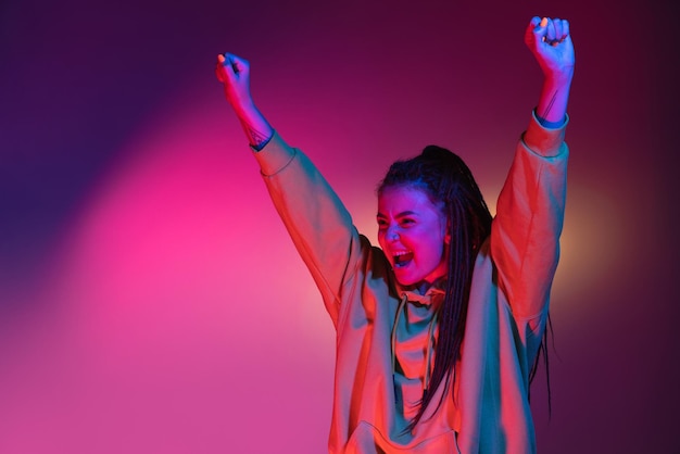 Foto gratuita ritratto di giovane donna su sfondo di studio di colori sfumati al neon concetto di emozioni umane