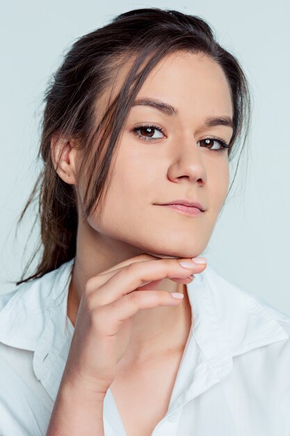 The young woman's portrait with thoughtful emotions on blue space