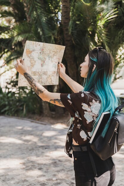 Young woman searching direction in the map