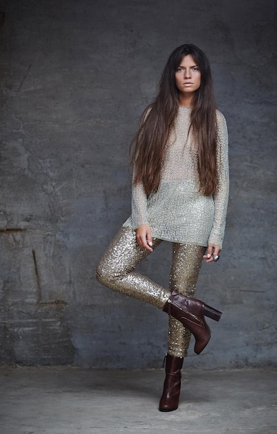 Free photo young woman in shine clothes posing on camera.