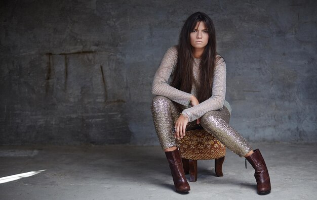 Young woman in shine clothes posing on camera.