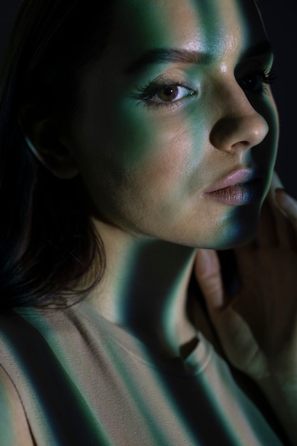 Free photo young woman shooting with projector close up