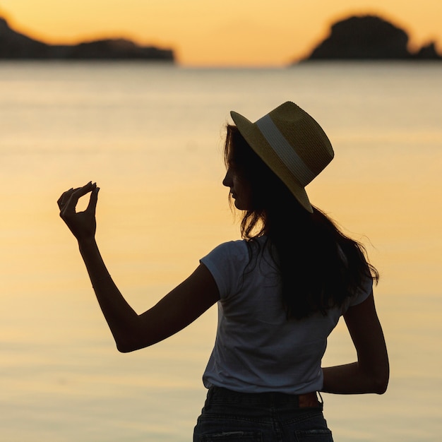 Young woman on the shore of a lake