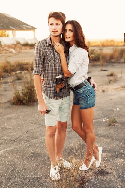 Young woman in shorts hugging her boyfriend