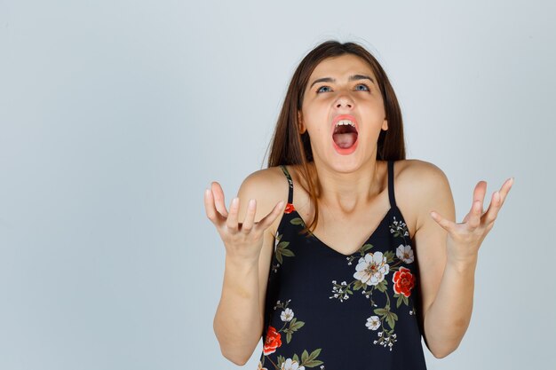 Young woman shouting, being displeased with dumb questions