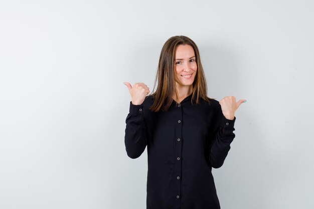 Young woman showing double thumbs up