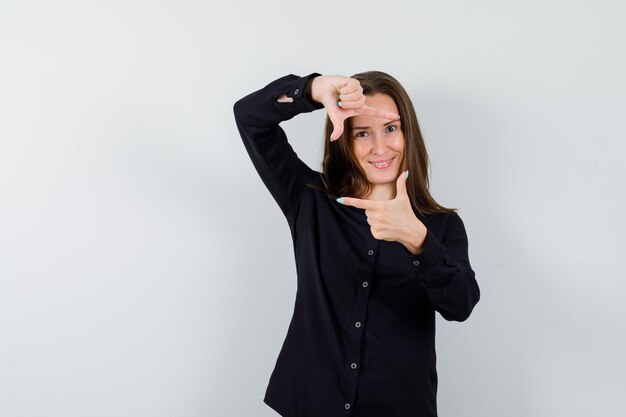 Young woman showing frame gesture