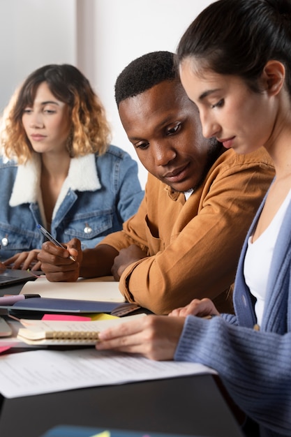 Young woman showing her friend something on a notebook