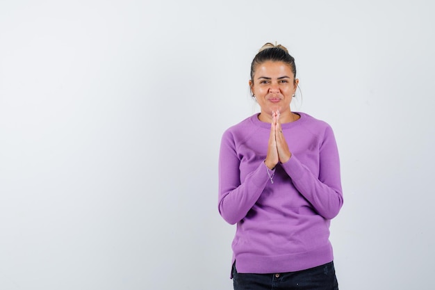 Young woman showing namaste gesture