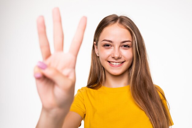 Young woman showing number three. isolated on white wall