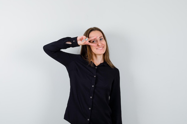 Young woman showing peace sign