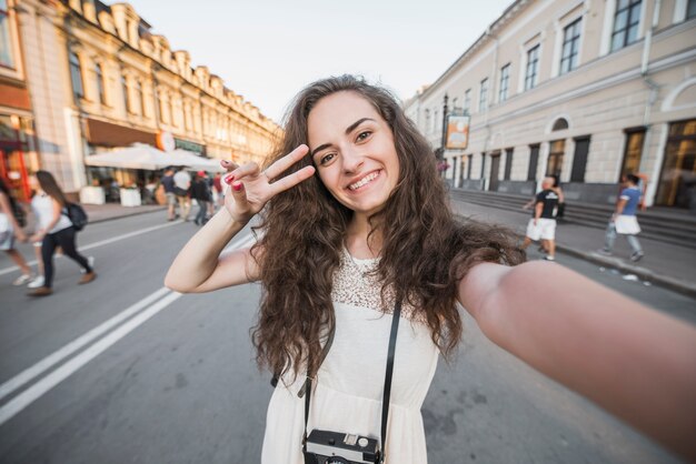 Young woman showing peace sign 