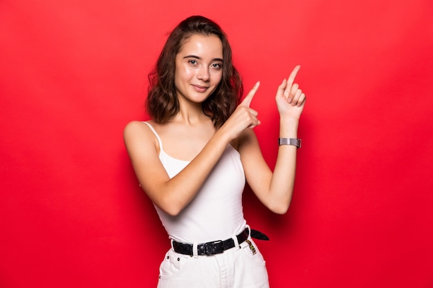 Young woman showing pointing up. Very fresh and energetic beautiful young girl smiling happy