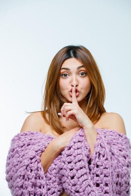 Free photo young woman showing silence gesture