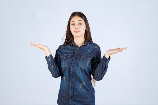 Young woman showing something in her open hand