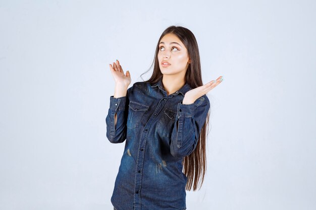 Young woman showing something in her open hand