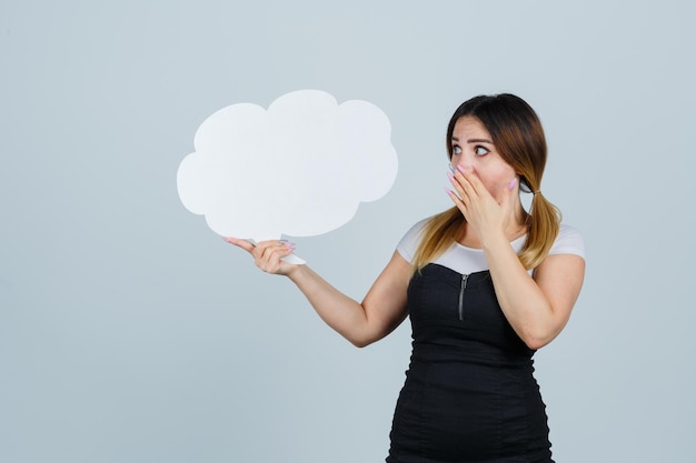 Free photo young woman showing speech bubble