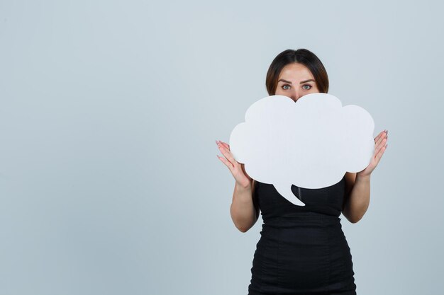 Young woman showing speech bubble