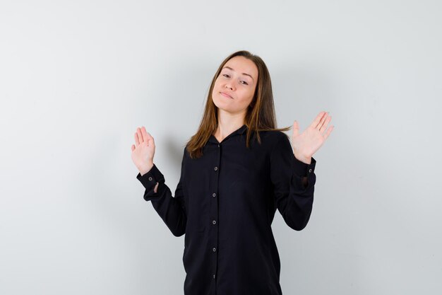Young woman showing surrender gesture