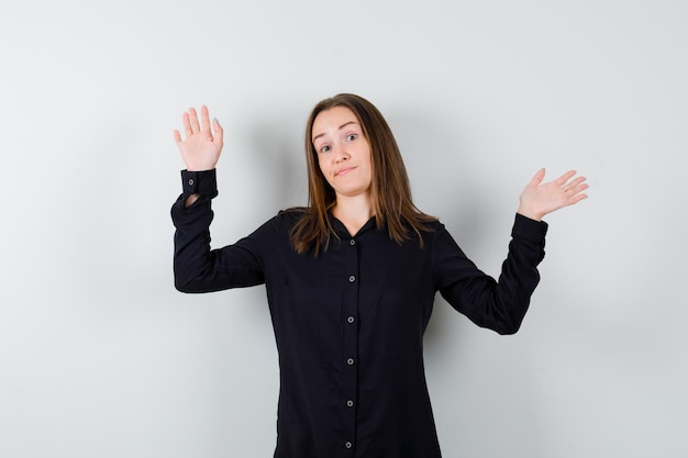 Young woman showing surrender gesture