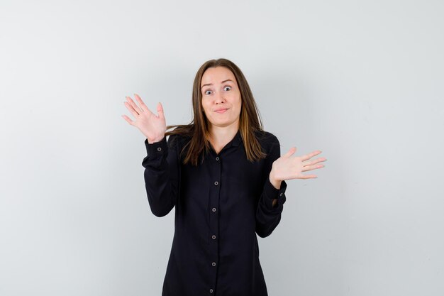 Young woman showing surrender gesture