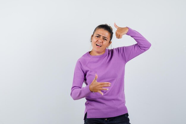 Young woman showing thumbs up