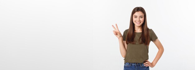 Young woman showing two fingers positive or peace gesture on white