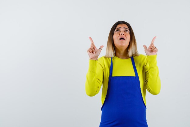 Young woman showing up with her fingers on white background