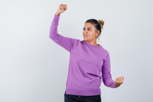 Free photo young woman showing winner gesture