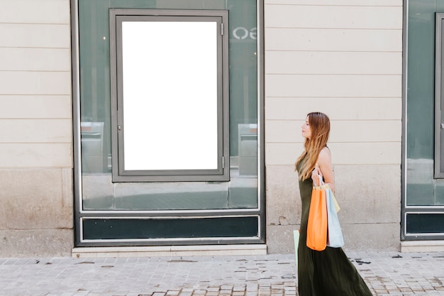 young woman shpping in the street and template