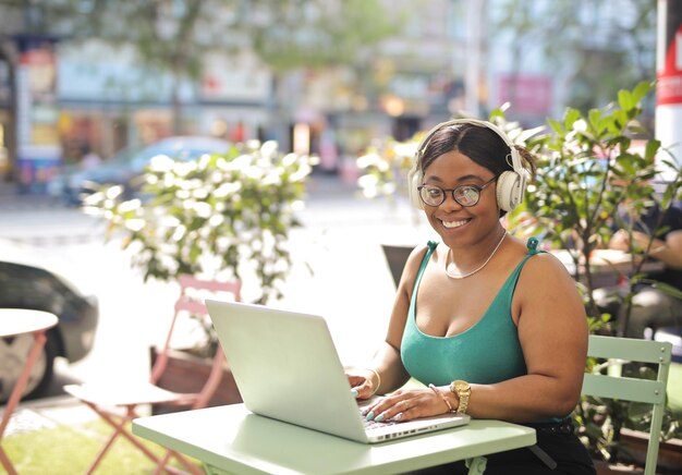 young woman sitting in a cafe with a computer