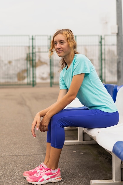 Young woman sitting on chair looking away
