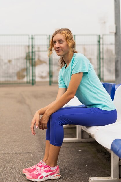 young woman sitting on chair looking away