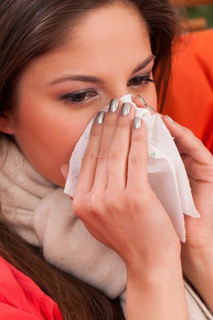 Young woman sitting at home with cold