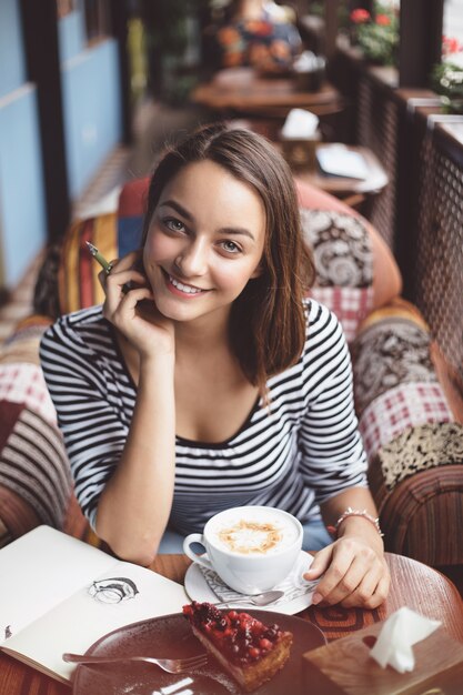 Young woman sitting indoor in urban cafe