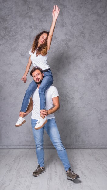 Young woman sitting on man shoulders