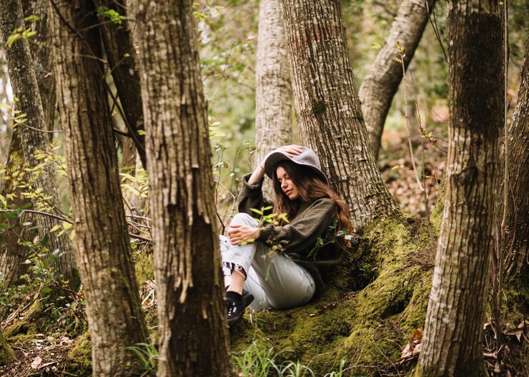 Free Photo young woman sitting in nature