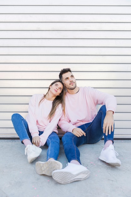 Free photo young woman sitting near handsome man