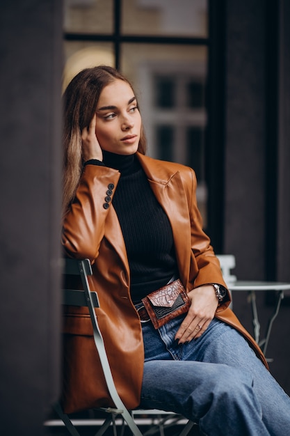 Young woman sitting outside the bar