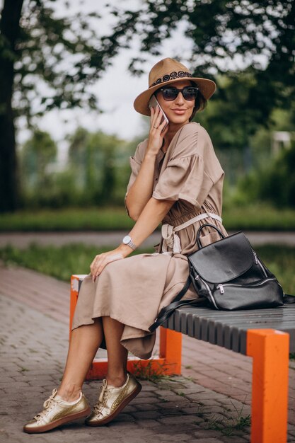 Young woman sitting park using phone