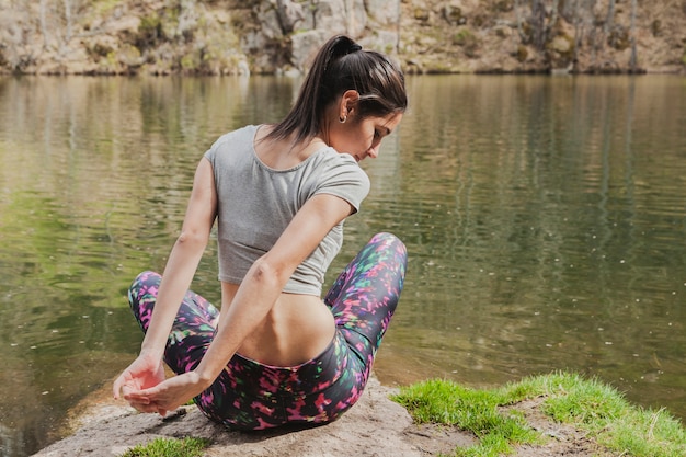 Young woman sitting stretching her arms