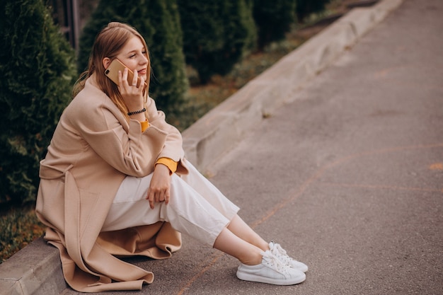 Young woman sitting and talking on the phone